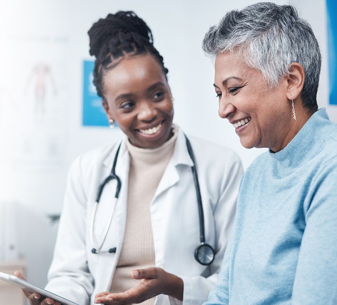 Healthcare professional speaking with an older adult